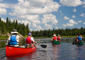 people on lake in canoes