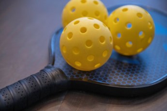 image of pickle ball bat and ball