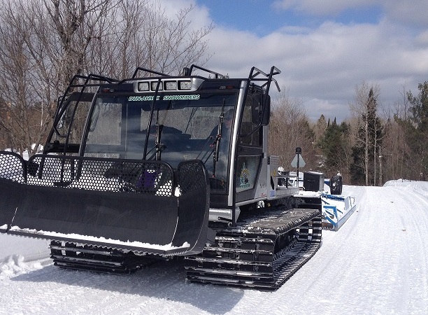 groomer on snowmobile trail