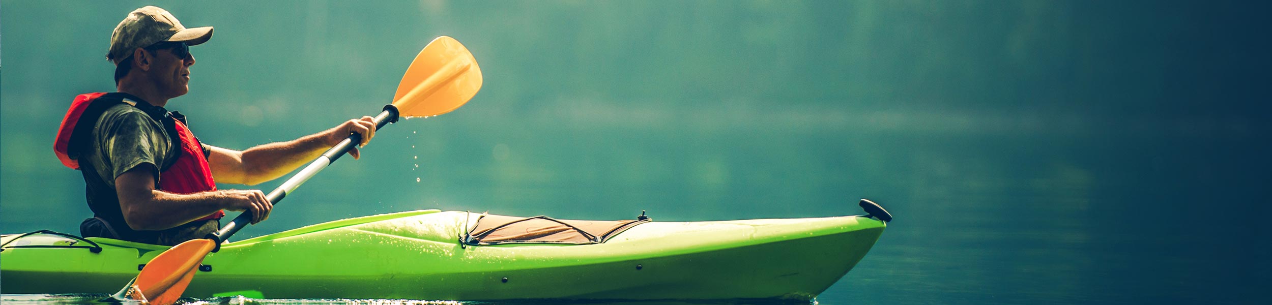 man in kayak on lake