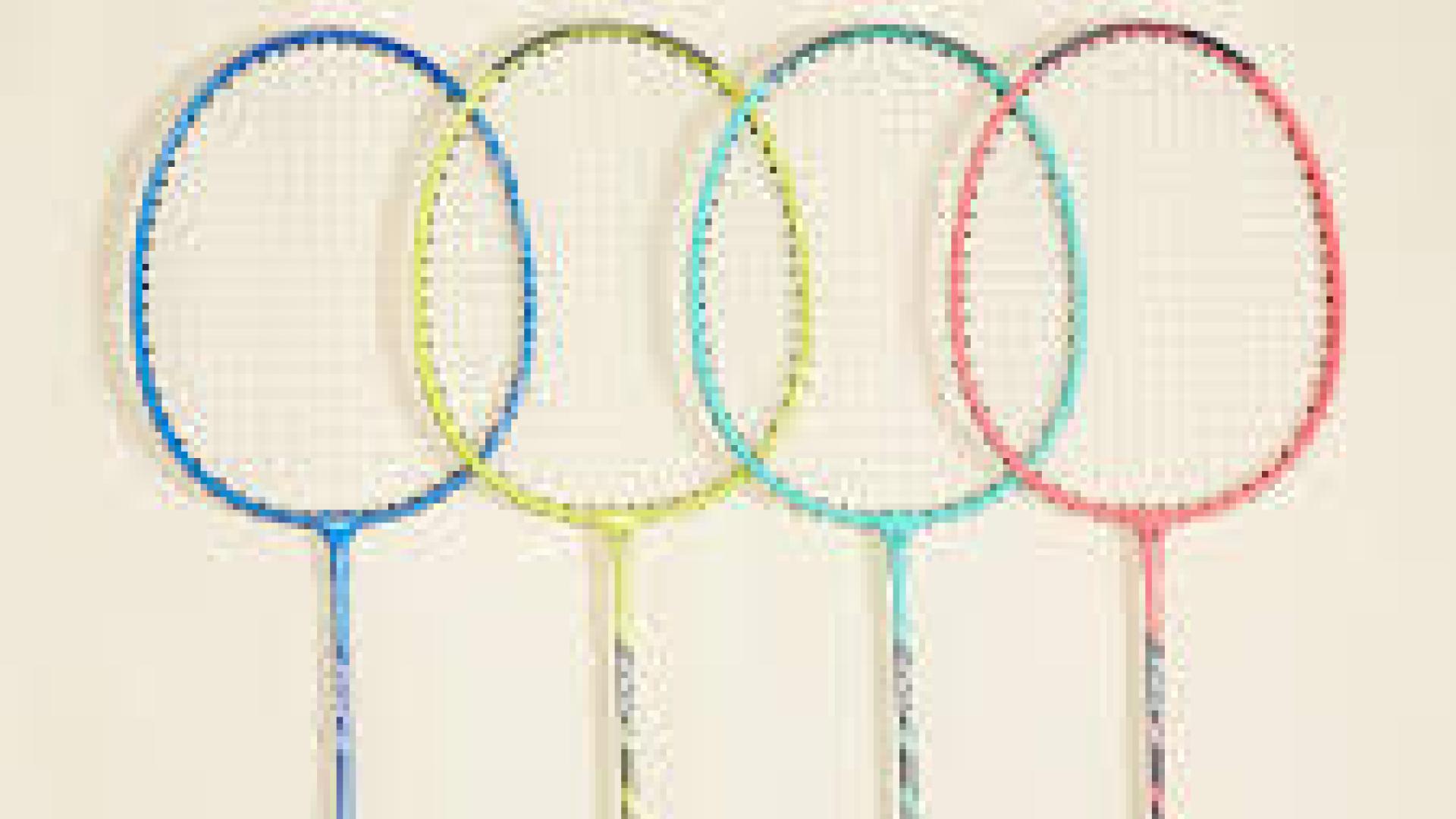 Four badminton rackets in blue, green, yellow, and pink, arranged side by side.