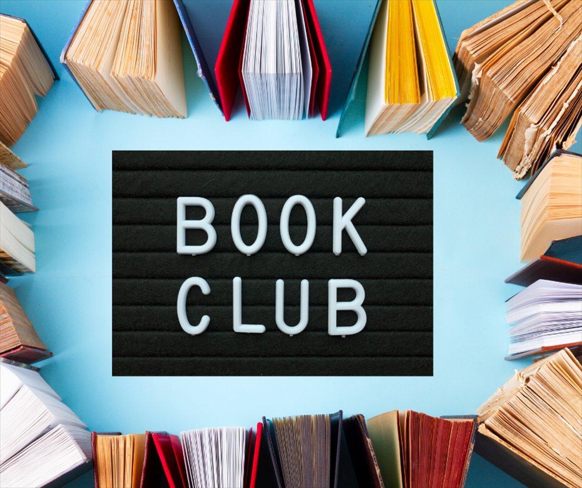 Books arranged in a circle around a "BOOK CLUB" sign.